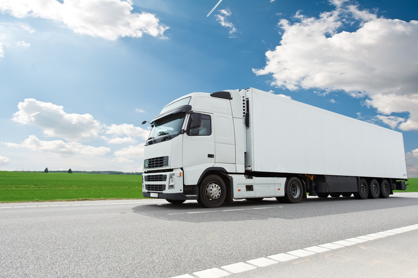 white lorry with trailer over blue sky